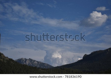 Fluffy white cloud formation between the Rocky Mountains 