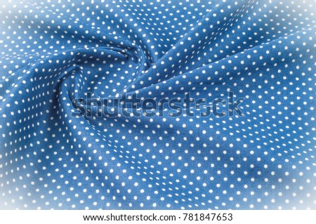 Texture background pattern. Silk fabric, blue cloth in white peas. On a black background. 