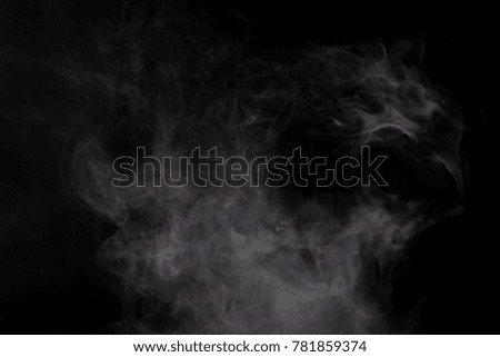 smoke from boiling steam on black background