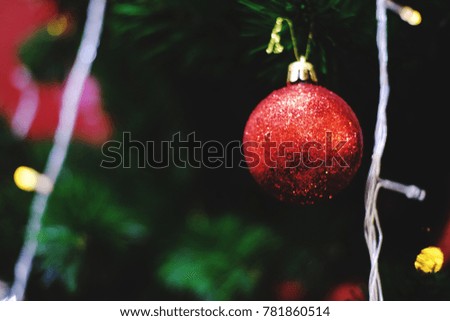 Red ball and ornaments of Christmas are hanging on Christmas tree with space for your text design,decorate for Christmas and Happy New Year festival. Blur picture and vintage style.