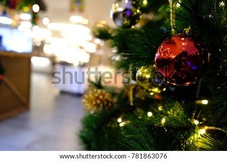 Red ball and ornaments of Christmas are hanging on Christmas tree with space for your text design,decorate for Christmas and Happy New Year festival. Blur picture and vintage style.