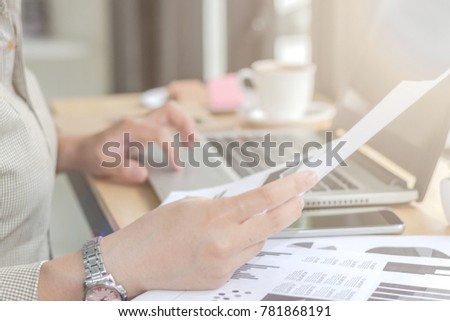 Close Up of woman hands using mobile phone and laptop computer with blank copy space screen for your advertising text message or content business at a coffee shop with a document.