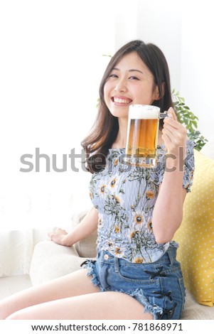 Young woman takeing alcohol at home
