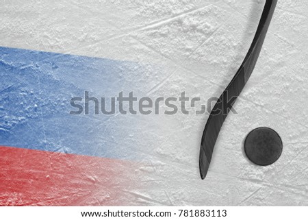 Hockey puck, stick and the image of the Russian flag on the ice. Concept, hockey
