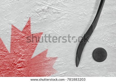 Hockey puck, stick and Canadian flag on ice. Concept, hockey
