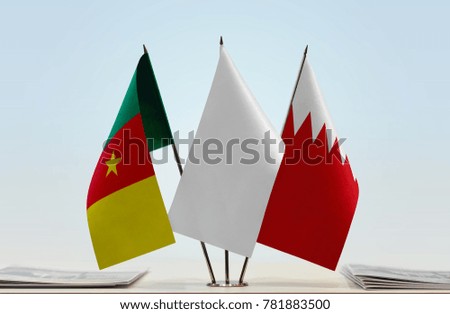 Flags of Cameroon and Bahrain with a white flag in the middle