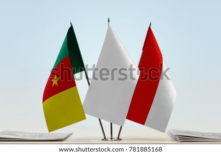 Flags of Cameroon and Indonesia with a white flag in the middle