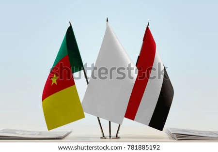 Flags of Cameroon and Yemen with a white flag in the middle