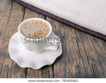 Coffee cups and towels on a wooden table