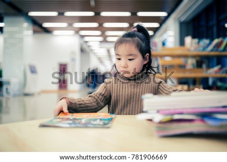 The lovely young asian girl who reads books in the library
