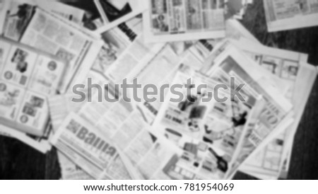 Newspapers on the table, top view. Blurred background texture