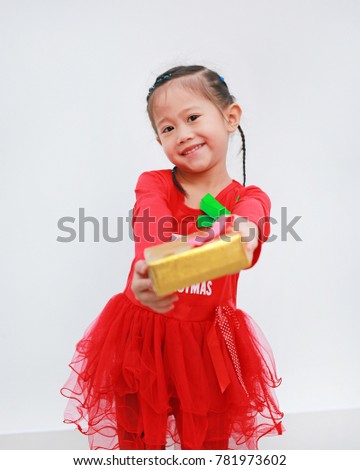 Cute little Asian girl in red dress holding gift box with looking at camera and smiling on white background.