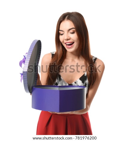 Beautiful young woman opening box with gift for Valentine's Day on white background