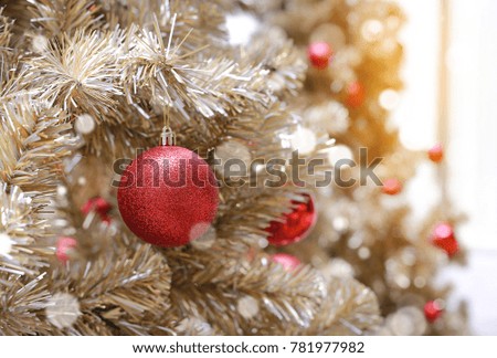 Christmas tree and bauble hanging decorations at winter season.