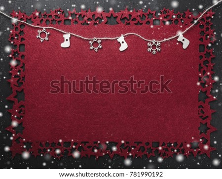 Handmade wooden toys hanging from a rope, Christmas greeting card, on red cloth snowy, snow background, view from above, with free space for text writing