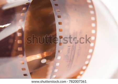 A beautiful closeup of an analogue photo film on a white background. Shallow depth of field.