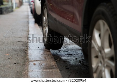 Bad car parking with part of the rear tyre on the pavement Royalty-Free Stock Photo #782020954