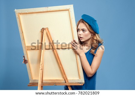  surprised painter on a blue background, draw, easel with canvas, art                              
