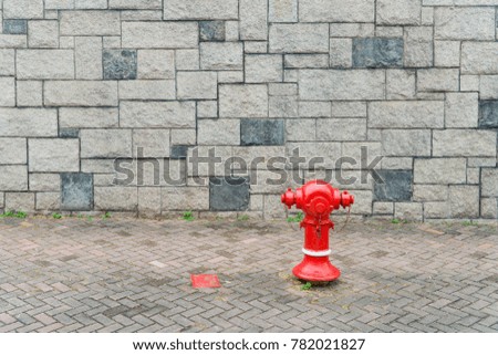 Fire hose water outlet red brick wall gray background