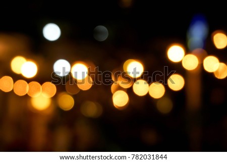 Abstract blurred and bokeh reflection lighting of candles in the Thai temple.