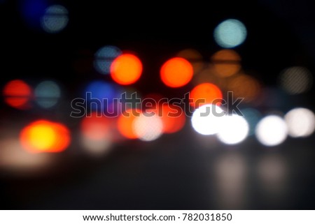 Blurred and bokeh reflection lighting of cars head light on the road with traffic night time in the city.