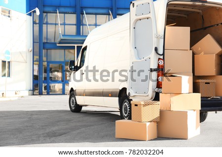 Open car trunk with moving boxes outdoors Royalty-Free Stock Photo #782032204