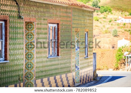 Small portuguese house covered with traditional tiles, Algarve
