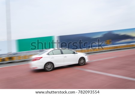 White car speed running on the road.motion picture blurred.