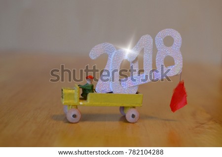Number 2018 on old wooden toy car. A truck with a big new year number