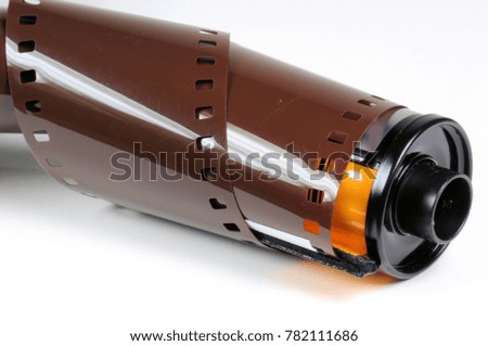 twisted film strip with roll on white background.