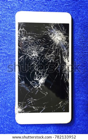 White screen phone cracked on blue background.