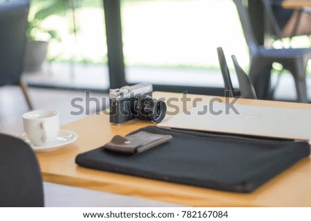 Camera and laptop on the table.