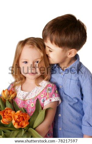 Portrait of beautiful smiling kids isolated on white background; pretty little boy kissing cute little girl