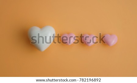 Love in process. Valentine's hearts on color background with copy space. Symbol of love. Happy Valentines Day background.Saint Valentine's Day concept. 
