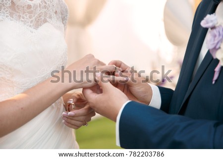 Couple holding hands during wedding ceremony 