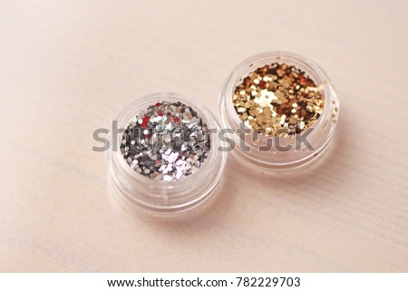 Gold and Silver Sequins for the design of nails in a box. Glitter in jars. Foil for nail service. Photo set. Sparkling beauty shimmer, glitter.