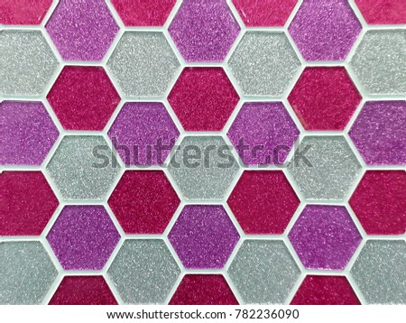 Closeup Texture of Colorful Acrylic Tiles in Pink / Red Shade with Hexagonal or Beehive Shape for Wall, Floor, Interior Works, Background, Backdrop, or Wallpaper.  Photo Taken by Mobile Phone