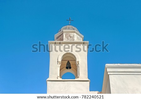 white bell tower building in blue sky