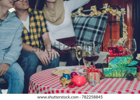 Group of friends to enjoy new year party filled with gift boxes a variety of colors and food champagne. They celebrated until the morning in the living room.
