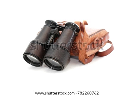 Old binoculars with leather case on white backgkround