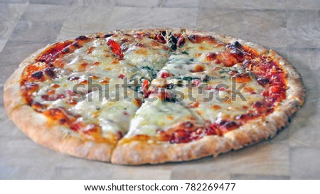  close up of home made pizza Italian dish with cheese topping with a lot of ingredients served at a restaurant or take away, copy space for texting.  