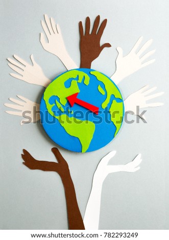 Paper cut design. Humans hands holding the planet Earth and red arrow pointing on North America.