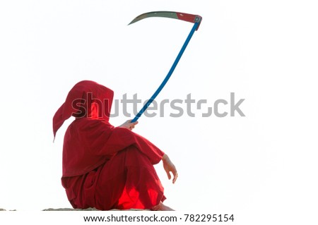 Spooky figure in red cloack with scythe