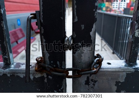 Rusted door, chain locked shut. Close Up.