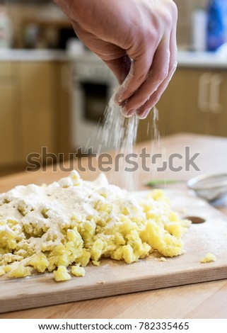 Hand of cook making dough for italian gnocchi pasta.