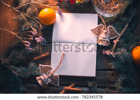 New Year's background. Notepad on wooden boards with decorations.