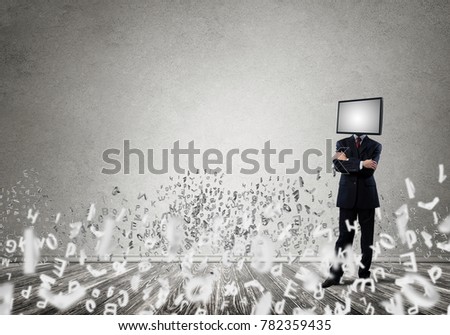 Businessman in suit with TV instead of head keeping arms crossed while standing among flying dollar banknotes inside empty room with gray dark wall on background.