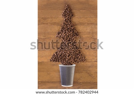 Coffee beans 
in the form of a Christmas tree on wooden background