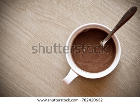 Coffee cup top view on wooden table background.