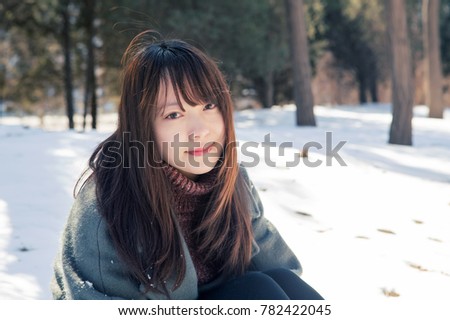 Beautiful Asian women playing in the snow